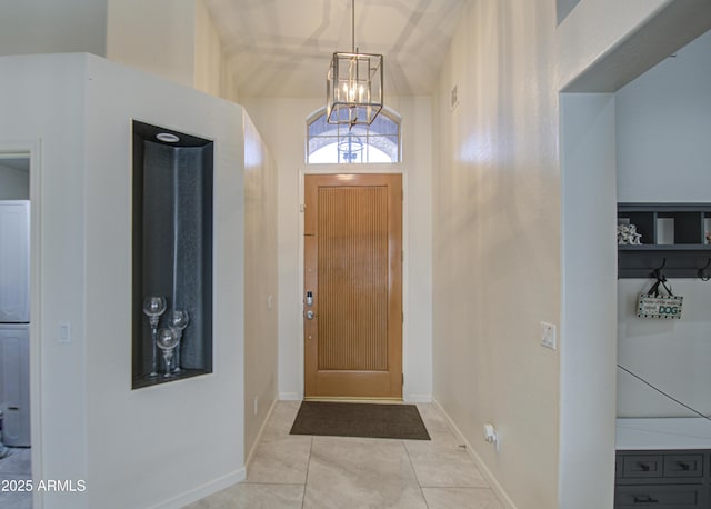 entryway with a notable chandelier and light tile patterned flooring