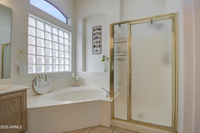 bathroom with vanity, plenty of natural light, and separate shower and tub