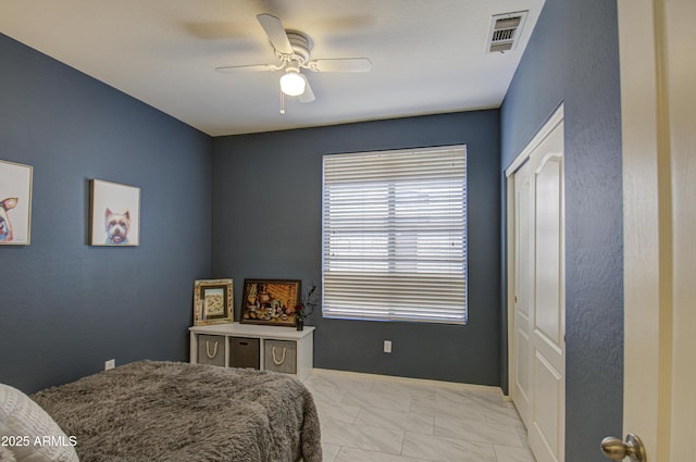 bedroom featuring ceiling fan and a closet