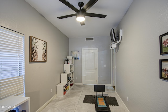 interior space with ceiling fan