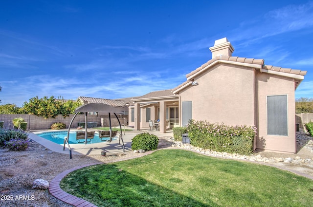 view of swimming pool featuring a patio area and a lawn