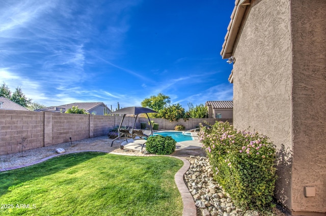 view of yard with a fenced in pool and a patio