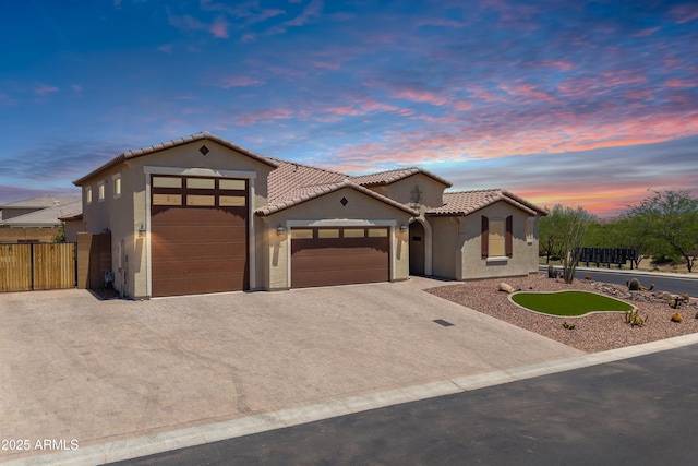12516 W Mclellan Ct, Glendale, AZ 85307 - mediterranean / spanish house featuring a garage, concrete driveway, a tiled roof, and stucco siding