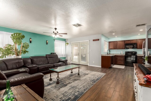 4712 W Juniper Ave, Glendale, AZ 85306 - living room with plenty of natural light, dark wood-style flooring, a textured ceiling, a ceiling fan, and recessed lighting