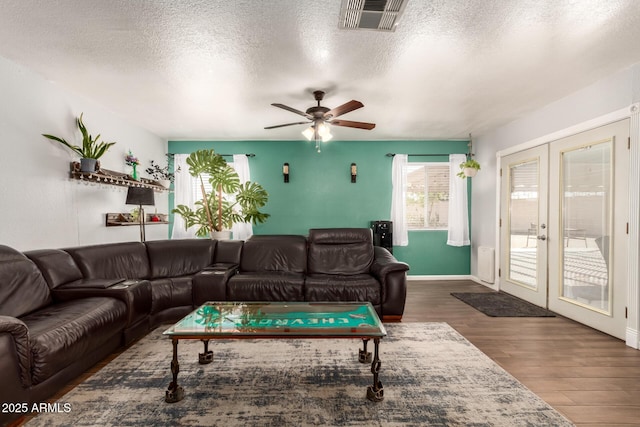 4712 W Juniper Ave, Glendale, AZ 85306 - living room featuring french doors, wood finished floors, ceiling fan, and a textured ceiling