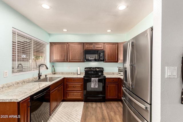 4712 W Juniper Ave, Glendale, AZ 85306 - kitchen featuring black appliances, light countertops, light wood-style floors, brown cabinets, and recessed lighting