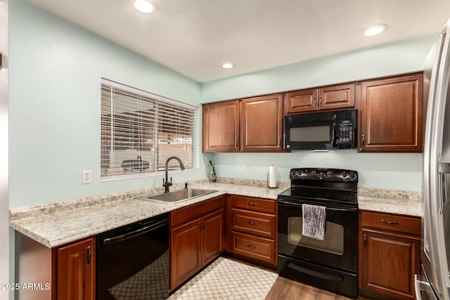 4712 W Juniper Ave, Glendale, AZ 85306 - kitchen featuring black appliances, light countertops, brown cabinetry, wood finished floors, and recessed lighting
