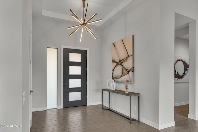 foyer entrance featuring hardwood / wood-style floors and an inviting chandelier