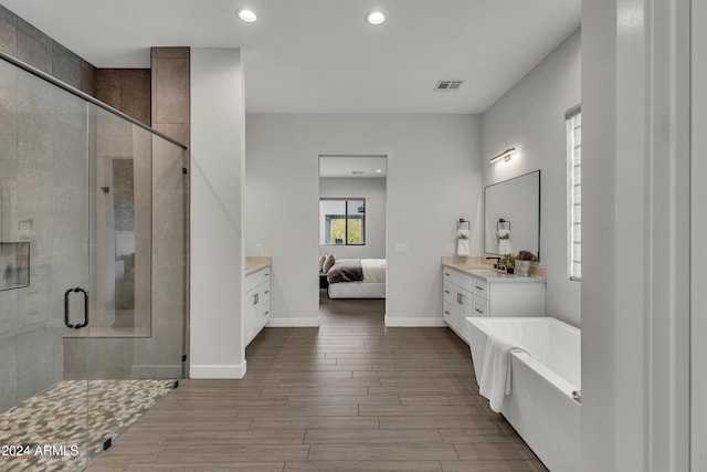 bathroom with vanity, wood-type flooring, and shower with separate bathtub