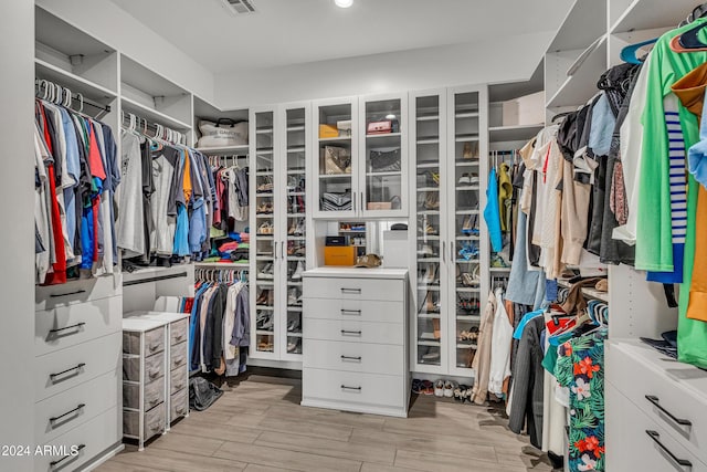 walk in closet featuring light hardwood / wood-style floors