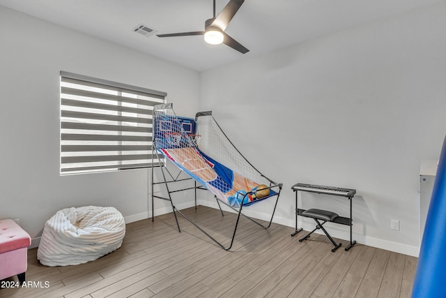 rec room with ceiling fan and light wood-type flooring