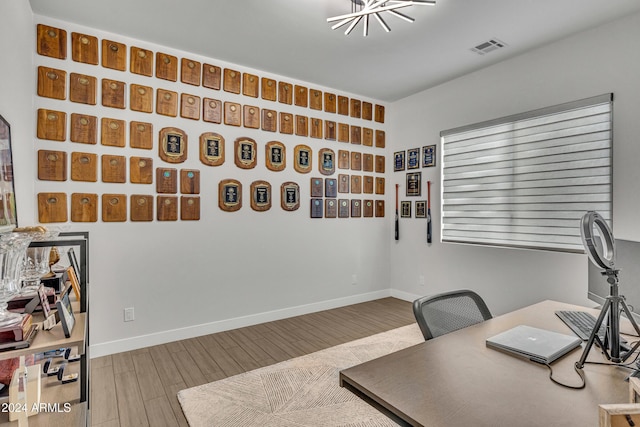 office area featuring a chandelier and hardwood / wood-style flooring