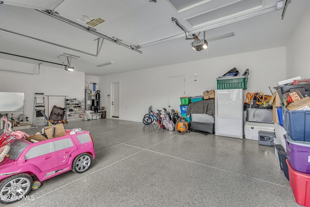 garage with electric water heater and a garage door opener