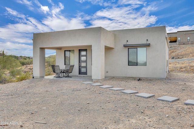 back of house with a patio