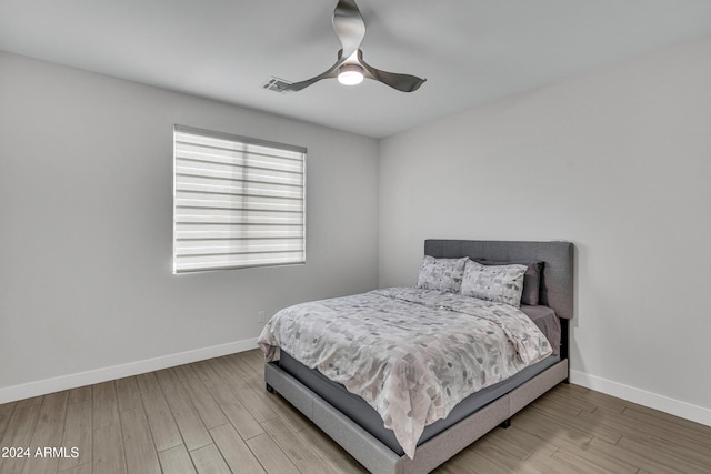 bedroom with ceiling fan and wood-type flooring