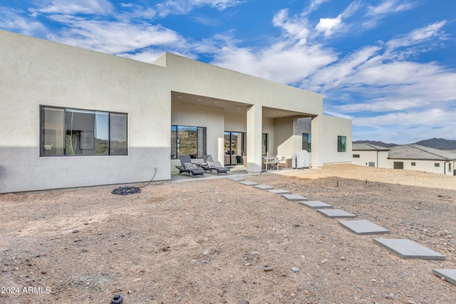 back of property with a patio