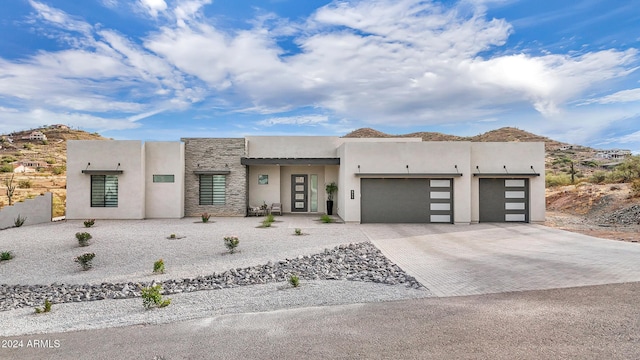 pueblo-style home with a mountain view and a garage