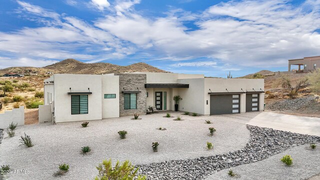 view of front of property with a mountain view and a garage