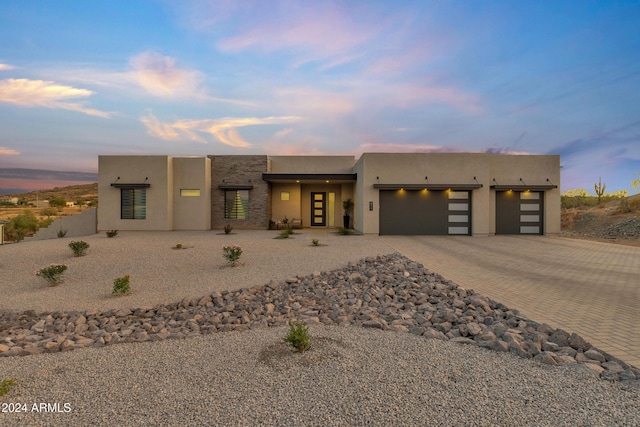 pueblo revival-style home with a garage