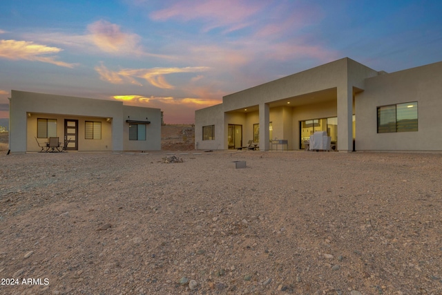 view of back house at dusk