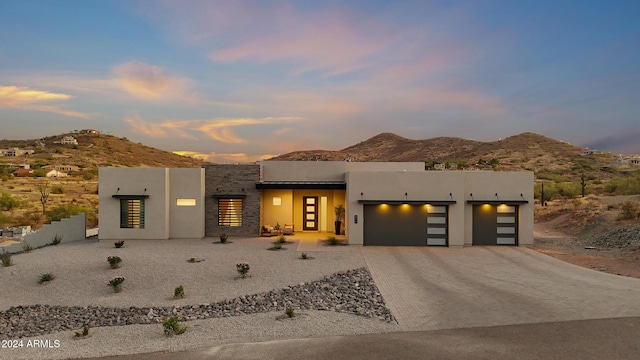 view of front of property featuring a mountain view and a garage