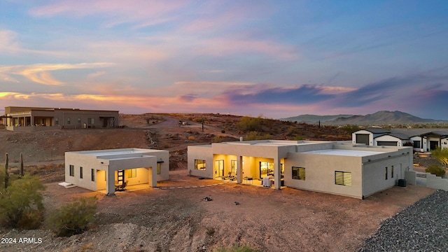 back house at dusk featuring a mountain view