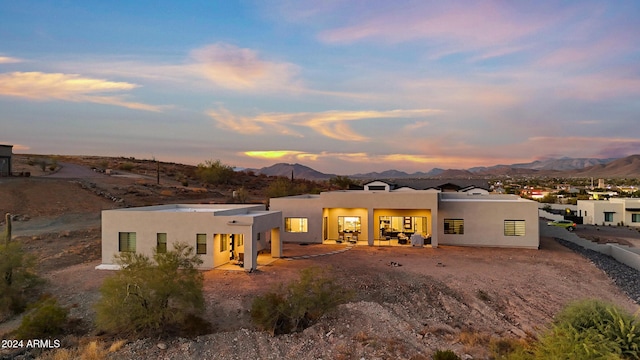 back house at dusk with a mountain view