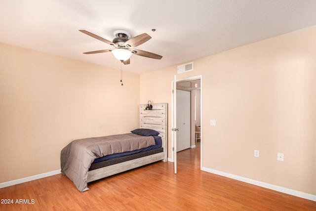 12221 W Bell Rd Unit 362, Surprise, AZ 85378 - bedroom with a ceiling fan, baseboards, visible vents, and light wood-type flooring