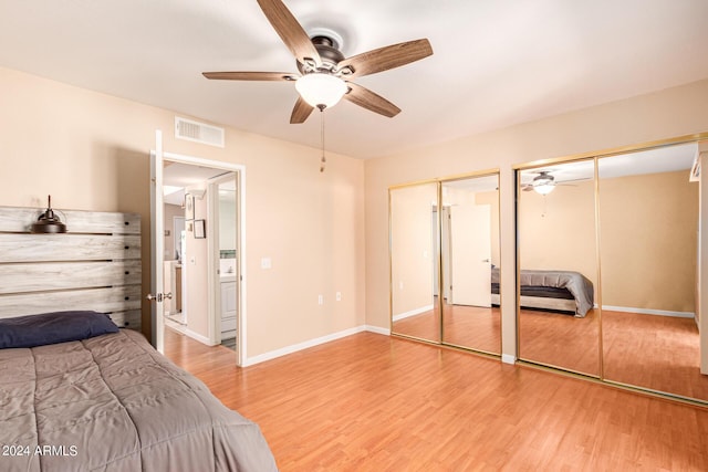 12221 W Bell Rd Unit 362, Surprise, AZ 85378 - bedroom with ceiling fan, multiple closets, baseboards, wood finished floors, and visible vents