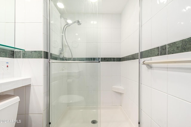 12221 W Bell Rd Unit 362, Surprise, AZ 85378 - bathroom with toilet, tile walls, and a stall shower