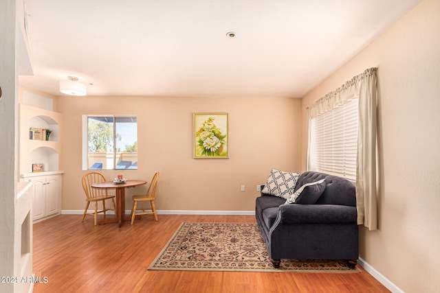 12221 W Bell Rd Unit 362, Surprise, AZ 85378 - living area with baseboards, built in features, and light wood-style flooring