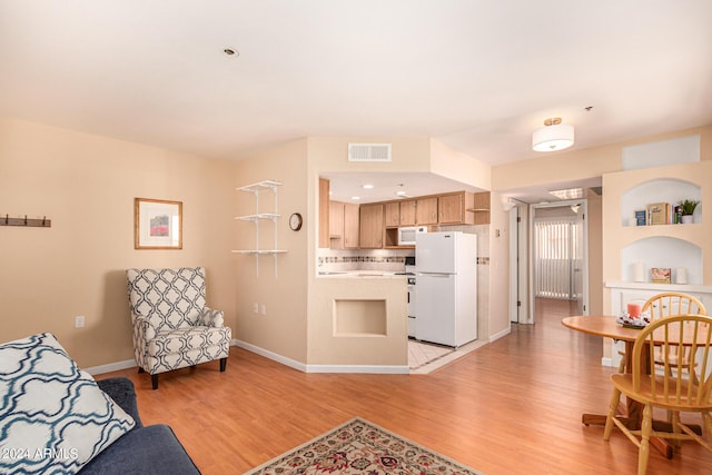 12221 W Bell Rd Unit 362, Surprise, AZ 85378 - living area with baseboards, visible vents, and light wood-style flooring