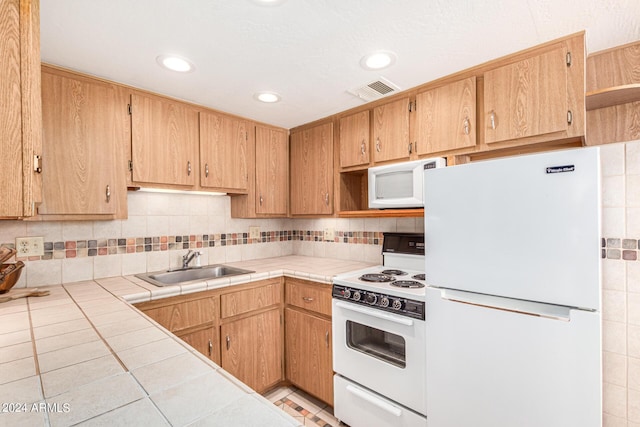 12221 W Bell Rd Unit 362, Surprise, AZ 85378 - kitchen with a sink, white appliances, tile counters, recessed lighting, and tasteful backsplash