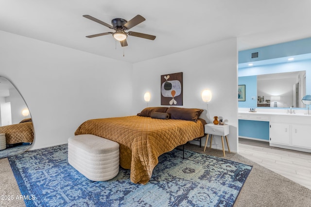 carpeted bedroom with ceiling fan, sink, and connected bathroom