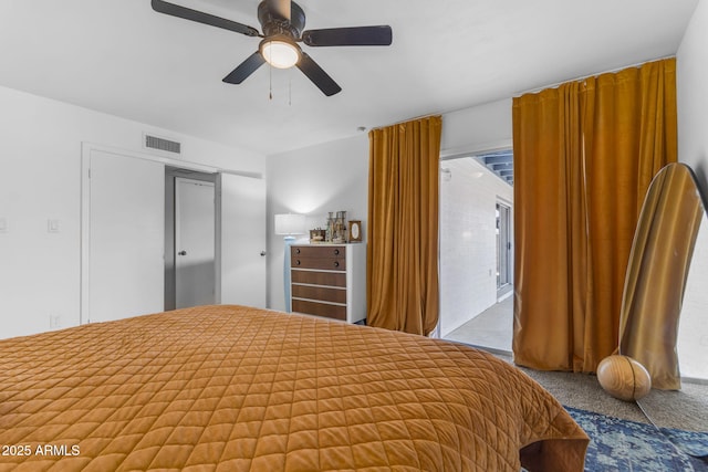 carpeted bedroom featuring ensuite bath and ceiling fan