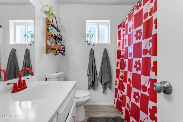 bathroom featuring wood-type flooring, vanity, toilet, and walk in shower