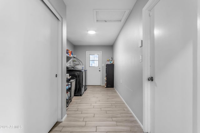 hallway with washer and clothes dryer