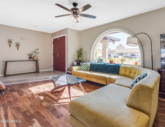 living room featuring ceiling fan and hardwood / wood-style flooring