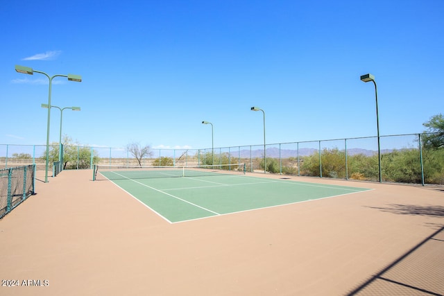 view of tennis court featuring basketball court