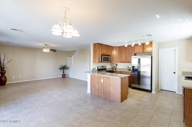 kitchen featuring hanging light fixtures, light tile patterned floors, kitchen peninsula, stainless steel appliances, and ceiling fan with notable chandelier