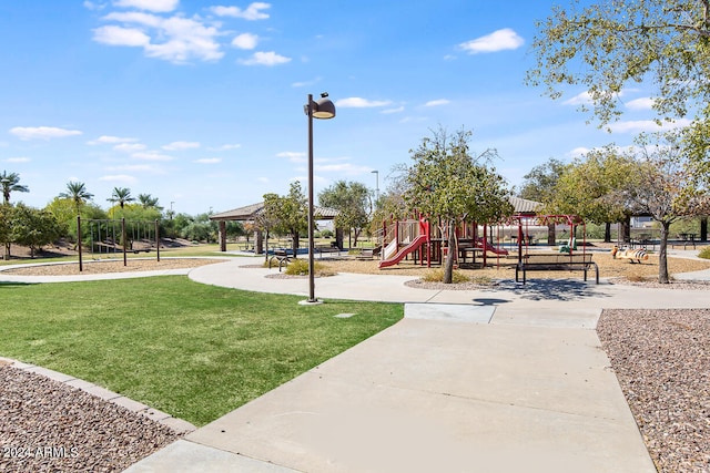 view of property's community with a playground and a yard