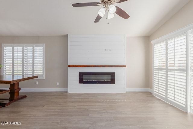 unfurnished living room featuring light wood-type flooring, ceiling fan, and lofted ceiling