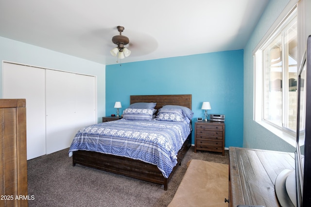 carpeted bedroom featuring ceiling fan and a closet