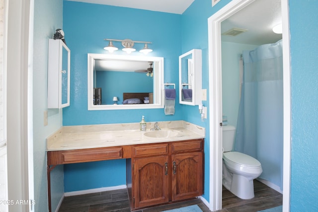 bathroom featuring visible vents, baseboards, toilet, wood tiled floor, and vanity