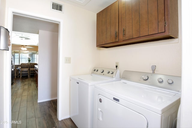 washroom featuring cabinet space, visible vents, dark wood finished floors, ceiling fan, and washing machine and dryer