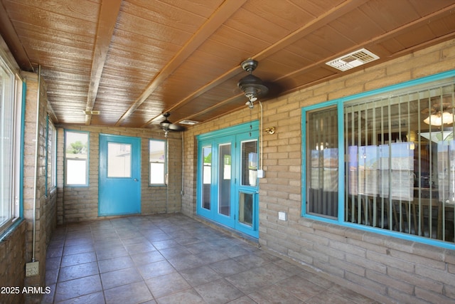 unfurnished sunroom featuring wooden ceiling and visible vents