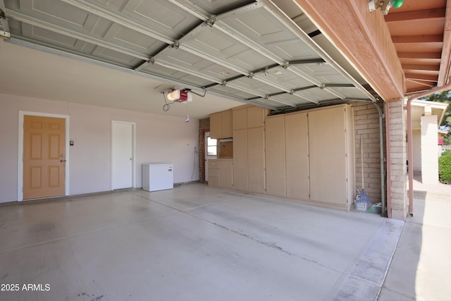 garage with a garage door opener and refrigerator