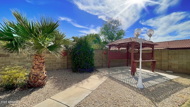 view of yard with a gazebo, a fenced backyard, and a patio