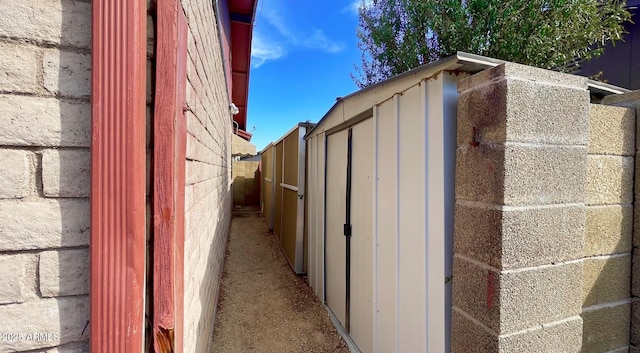 view of outbuilding featuring an outbuilding and fence