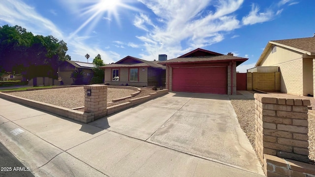 single story home featuring driveway, a garage, and brick siding